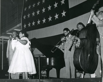 Louis Armstrong and a band; from left to right 'Satchmo' Armstrong, Velma Middleton, Trummy Young, two unidentified band members.  Others appearing were Billy Kyle, Danny Barcelone, and Edmond Hall.