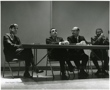 'Prof. of physics-at-large and legendary 'Father of the H-Bomb' Edward Teller (second from left) is shown at a panel discussion at the Oct. 6, 1967 Science-Writing symposium. Also shown are panelists Adam R. Kelly, editor of the Tyler County Star (left); Harvey Rexroad, WVU prof. of physics (second from right); and George Diab, vice-president of WTRF-TV in Wheeling (right).