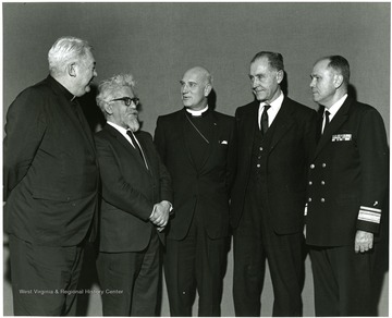 'The four main speakers and the Moderator of the their panel session of the Jan. 7-9, 1968 'Man and His Religions' symposium are shown from left to right: Rev. Eugene Burke, Trinity College and St. Paul's College in Washington; Dr. Abraham J. Heschel, Jewish Theological Seminary of America in New  York City; moderator the Rt. Rev. Wilburn C. Campbell, bishop of the West Virginia Episcopal diocese in Charleston; Dr. Harold Bosley, Christ Methodist Church of New York City;  and Admiral James W. Kelly, chief of chaplains of the United States Navy.' 