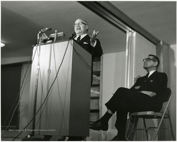 'Harvard University historian Oscar Handlin speaks at Feb. 23, 1967 lecture as part of the Lessons of History symposium, as planning committee chairman John Caruso listens in the background.'