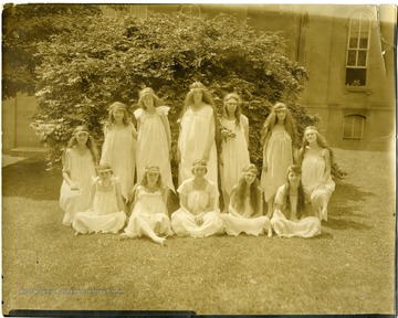 Female students of aesthetic dancing group pose in Woodburn Circle. Back row from right: Miss Lester; Gracia Remsburg; Emma Myers; Mary Curran; Oney Dent; Elsie Happel; Mildren Eastwood.  Front row from right: Beulah Carson; Rachel Remsburg; Miss Rymer; Mrs. Waston and Bebby. 