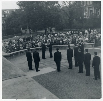An initiation ceremony is carried out for Helvitia Society on a plaza in front of Library.