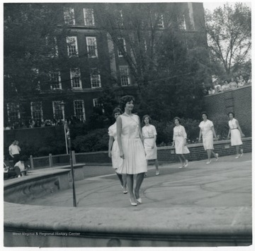 An initiation to Chimes, the Junior Women's Honorary, takes place on a plaza outside of the Library.