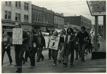 WVU Students march up High Street from the Post Office to Mountainlair. Front left, with the sign 'Stop The Draft' is Jack Calhoun, Vietnam Veteran, Resister, National Speaker, and Writer.  