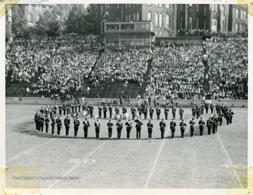 WVU marching band performs in formation on the field.