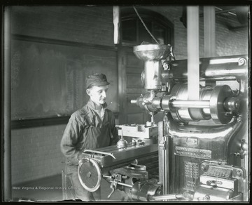 A worker at machine housed in the Mechanical Hall.