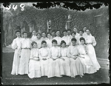 22 female students pose in front of Commencement Hall.