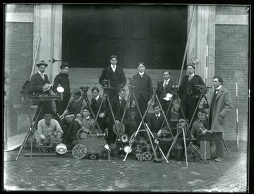 Students pose in front of Chitwood (Science) Hall with survey equipment.
