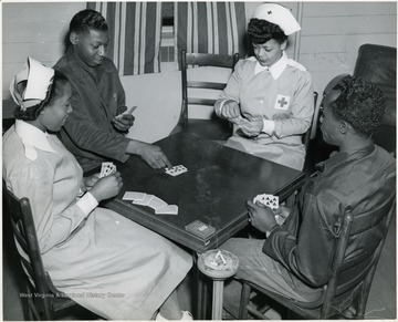 'Bridge, always a favorite game at Lockbourne Army Air Base Station Hospital, Columbus, is being played by Gray Lady Mrs. Henry T. Myrick, 256 Lexington Avenue, Columbus, Pvt. James Cumberbatch, 448 Lexington Avenue, Brooklyn, N.Y.; Mrs. Charles D. Allen, American Red Cross Franklin County Chapter Gray Lady, 84 North 17th St., and 1st Lt. Fabian O. Francis, 316 W. 12th St., New York, N.Y.'