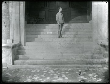 An unidentified male student on steps of Science Hall (present Chitwood Hall).