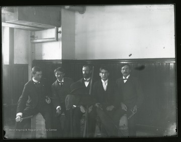 Five students seated in a room.