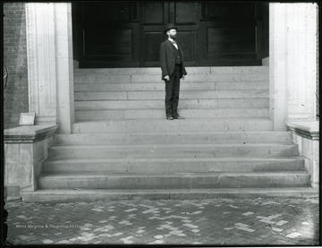 Elmer Leach stands on steps of Science or Chitwood Hall.