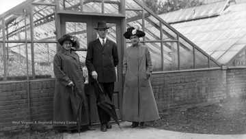 A. J. Dadisman in the middle with Nail and Allender in front of green houses.
