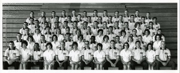 Class of Physical Education students, 1966, sitting on the bleachers inside of Stansbury Hall, West Virginia University.