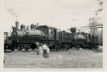 'Train climbing mountain to Bald Knob, part way up at rest stop. Type: 3 Truck Shays.  Builder: Lima Locomotive Works.  Builders No:  3373, 3189. Year: 7/28, 12/22.'
