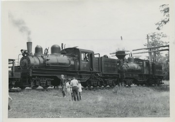 'Cass Scenic Railroad #2-4; Type: 3-Truck Shays; Builder: Lima Locomotive Works; Year: 7/28, 12/22 at Whittaker, W. Va. Builders Nos: 3373, 3189. Train climbing mountain to Bald Knob, part way up at rest stop.'  