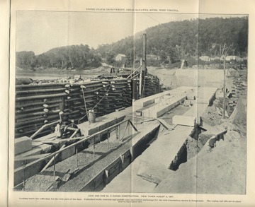 'U.S. Improvement, Great Kanawha River, West Virginia. Looking inside the cofferdam for the weir part of the dam. Unfinished walls, concrete and puddle core, and wicket anchorage for the weir foundations shown in foreground. The coping and sills are in place next to the center pier.'