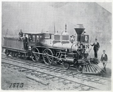 'Westward Ho - Delivered to Va. Central July 1857.  Picture taken at Winifred Junction 1870.  Andy F. Southworth, engineer, 'Barney' Hagen, fireman, standing on left side of pilot with tallow pot in his hand.'