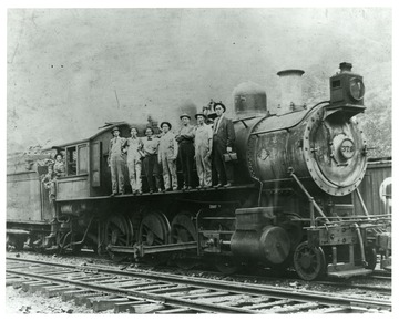 C. A. Ray and others are on a parked locomotive #378.
