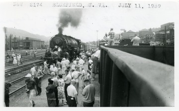 'N. &amp; W. #2174 on Roanoke-Ieager Cedar Bluff excursion.  July 11, 1959 at Bluefield, W. Va.  18 cars, 1 bay, 1 diner, 13 coaches and 3 gondolas on rear.'