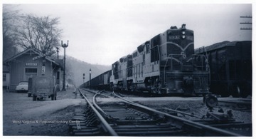 'C. &amp; O. GP9's 5932 and 6206 passing the depot on Logan Subdivision in May 1959 with hopper train.'