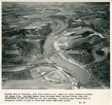 'Looking west at Allisonia, mile 170.2 about 4 p.m., April 27, after landing to refuel and change film.  Big Reed Island Creek entering under railroad bridge from left.  Excavations to left of river are old iron workings.  Recording gage installation of Geological Survey on bank of river near lower right-hand corner.'