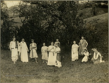 Student performers in togas and classical costumes. Taken on school property. Herscel D. Wade is the third person from the right.