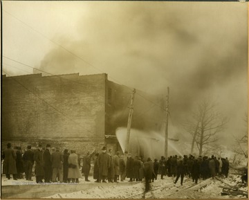 People watch as firemen try to put out the fire at S. C. Watkins Warehouse.