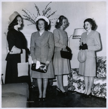 Four girls wearing wool suits.