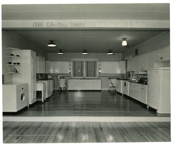 A display of modern kitchen with electric laundry machine.