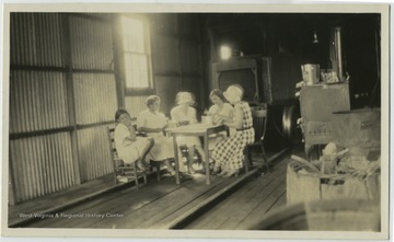 'Interior of mine bus garage at Henlawson, Logan Co. One big bus was run out, and other moved back so I could demonstrate there.'
