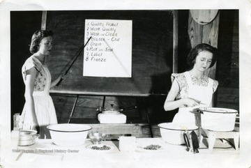 'Anna Wetzel and Delores Hurst demonstrate vegetable gardening. Other project training was given through project classes at camp, movies and slides shown in club meetings, judging activities and demonstrations by the members.  Simple demonstrations were a part of most club programs.'