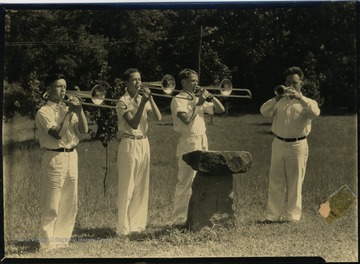 Boys with brass instruments - trombones and trumpet.