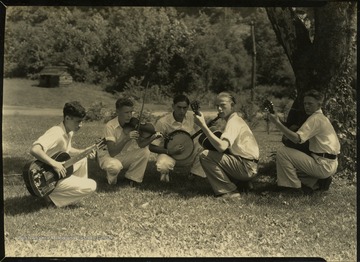 Boys with stringed instruments - guitar, violin, and banjo.