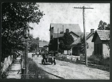 The car in the picture was the first Ford (Model T) in Auburn.  Driver/owner is Ira D. Cox.  Buildings (from right to left): Old Bank, Farnsworth Home, Brown Hotel, Gluck's Store and Pythians' Lodge Hall.