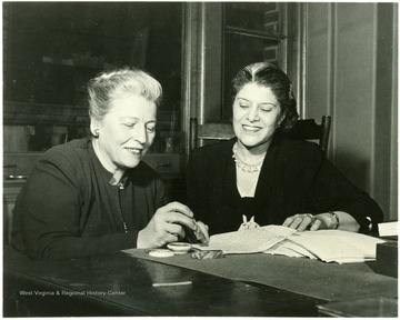 'Pearl Buck and Eslanda Goode Robeson look over the manuscript of their AMERICAN ARGUMENT, the fourth of Miss Buck's "talk books" each a record of a conversation with a citizen of one country or another.  In this new book to be published on January 24 by the John Day Co. these two American women, both mature, successful, and holding no grudges against life, discuss their own country from differing an sometimes opposing, but always basic, points of view.  Here is the way the Unite States looks to them as women, as mothers, as Americans, as world citizens and above all as human beings.  Their range of topics is wide--marriage, the education of children, the organization of home and career, women's place in the community, local and national, women and politics, our government, the hopes of the world.  Often they agree, sometimes they disagree sharply; throughout it is a firm but friendly argument.  Mrs Robeson is well known for her African Journey and other writings.'