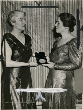 'Malvina Hoffman (Left), internationally famous sculptress and creator of the life-size reproductions of Racial Types for the "Hall of Man" of the field House in Chicago, receives from Pearl Buck, novelist, the American Woman's Association Award for Eminent Achievement Nov. 15 at the eleventh Annual Friendship Dinner at the American Woman's club.
