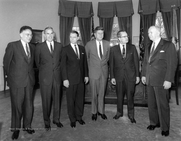Robert C. Byrd stands left of President Kennedy (third from right). Original moved to R.C.B. Center for Legislative Studies at Shepherd University.