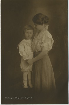 Portrait of a child holding hands with his mother.