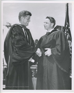 Senator Robert C. Byrd shaking hands with John F. Kennedy at a graduation ceremony.  Byrd Papers duplicate.  Original at the R. C. Byrd Center for Legislative Studies, Shepherd University.