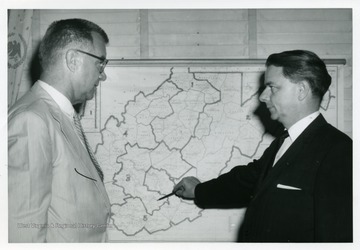 Senator Robert C. Byrd on the right pointing a map of West Virginia.