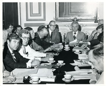 Robert C. Byrd 'in meeting, seated at the head of conference table.'