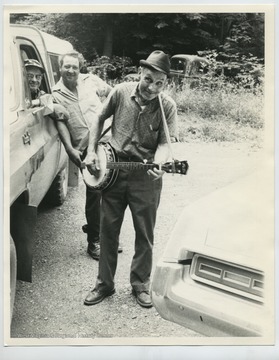Standing behind Davis is Don Turner; in the truck is Herbert Harper, the mail carrier.  Photo taken in Brushy Run across from Davis' home in Onego.  All three are deceased (2010).
