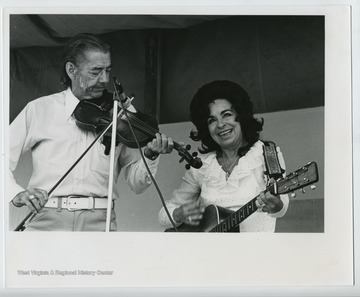 'Wilma Lee and Stoney Cooper, members of Grand Ole Opry, hillbilly recording stars. Wilma Lee is from Mill Creek, W. Va. (I think) and Stoney from around Harman, W. Va. Article in '[WV] Hillbilly in Oct. Nov. or Dec. '73 gives biography.'