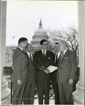 Underwood and group with capital in the background.