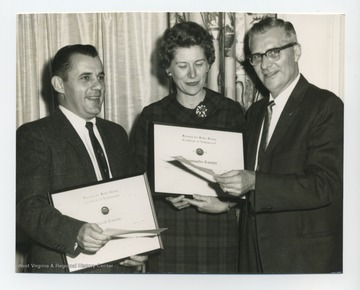 Betty Gum. 4-H Leader, with two other men, being presented a certificate. 