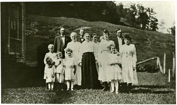 In the back row of Engle family portrait is H. E. Engle and Wesley Engle.