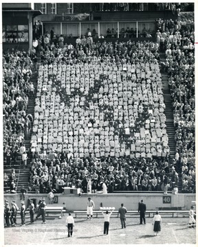 View of cheerleaders directing fans in their seats at the old stadium.
