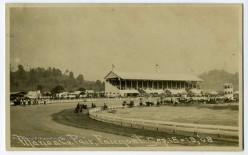 A view of Marion County fair, showing a horse race.