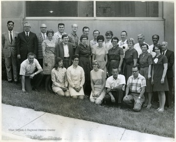 'The ones I know; Back row - Dr. Chak, Dr. I.D. Peters, Dr. Eaves; Second row - Betty Miller, Sam __'  Betty Miller is in the middle row, 6th from the right in the dark colored dress. 